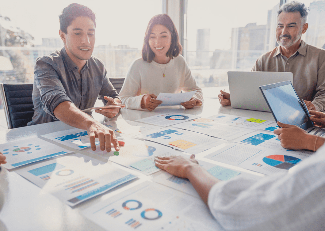 Business team discussing charts and graphs in a meeting.
